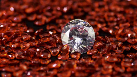 Real-brilliant-cut-shining-diamond-surrounded-by-the-heart-shaped-rubies-on-the-turntable-rotating-clockwise-close-up---highly-valuable-and-expensive-gemstones-for-fashion-and-weddings