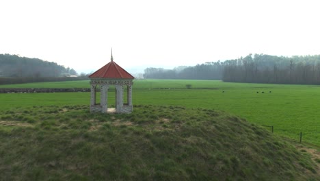 Drone-swooping-low-across-green-pastures-and-a-charming-gazebo-in-Helen,-GA