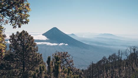 Majestic-volcano-peak-over-cloudscape-and-forestry-landscape-in-foreground,-Guatemala