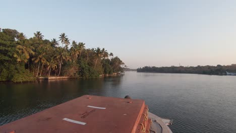 POV-of-boat-cruise-along-palm-tree-lined-banks-of-Alleppey-backwaters