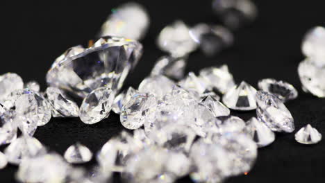 Slow-motion-macro-shot-of-real-glittering-brilliant-cut-various-sized-diamonds-throwing-on-the-sorting-table-in-a-jewelry-store-for-further-examination