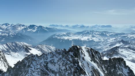 Mountaineer-on-a-rocky-peak-in-winter-in-the-Alps-of-South-Tyrol