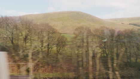 England-rural-countryside-from-inside-traveling-train-view
