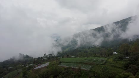 Low-mist-creating-greyish-scene-in-remote-rural-tropical-mountain-landscape