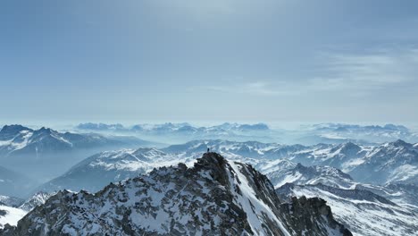 Climber-on-a-rocky-peak-in-winter-in-the-Alps-of-South-Tyrol