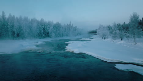 Vikakongas-River-Flowing-Through-Snowy-Forest-At-Winter-In-Finland