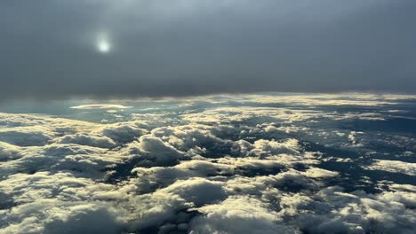 Aerial-view-from-a-cockpit-while-flying-trough-layers-of-clouds-before-sunset-in-a-winter’s-day