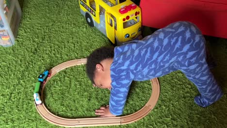 Two-year-old-afroeuropean-baby-playing-with-his-toy-train-at-home