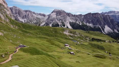 Val-Gardena-Valley-at-South-Tyrol,-Italian-Alps,-Dolomites,-Italy---Aerial-Drone-View-of-Tourists-Walking-the-Hiking-Trail-to-the-Top-of-Mount-Seceda