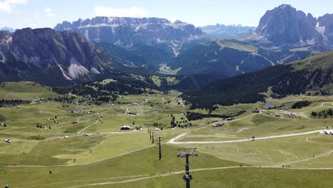 Val-Gardena-Valley-at-South-Tyrol,-Italian-Alps,-Dolomites,-Italy---Aerial-Drone-View-of-Cable-Chairlift-to-the-Top-of-Mount-Seceda