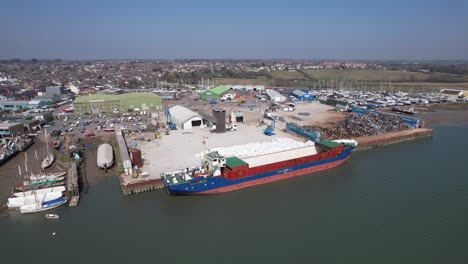 Ship-loading-at-Brightlingsea-Essex-UK-drone-aerial-reveal-pull-back-footage