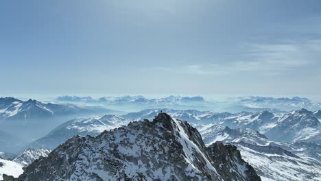 Drohnenaufnahme-Eines-Kletterers,-Der-Auf-Einem-Felsigen-Gipfel-In-Den-Alpen-Steht