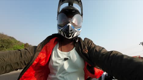 indian-bike-rider-with-jacket-riding-motorcycle-on-indian-road-sports-helmet-blue-sky-pov-action-camera-cam-footage