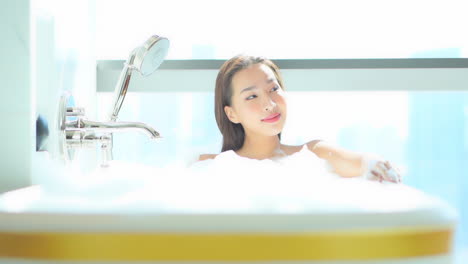 A-very-attractive-woman-with-flawless-skin-is-neck-high-in-a-bubble-bath