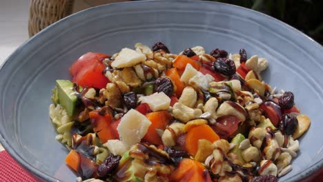 Bowl-Of-Fresh-Vegetable-Salad-With-Balsamic-Sauce-And-Chopped-Cashew-Nuts