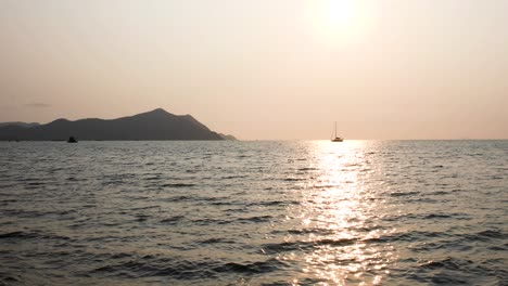 Beautiful-Thailand-with-a-Yacht-on-the-Horizon-in-Bangsaray-During-a-Sunset-Near-Pattaya,-Thailand