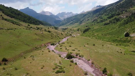 Spanish-Pyrenees,-Spain---Aerial-Drone-View-of-the-Riverbed-and-Green-Valley-of-Valle-de-Aguas-Tuertas