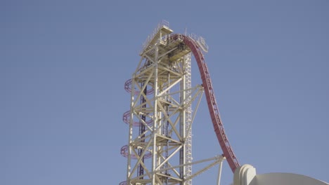 Gorgeous-footage-of-a-roller-coaster-climbing-a-steep-lift-hill,-and-then-plunging-down-towards-earth