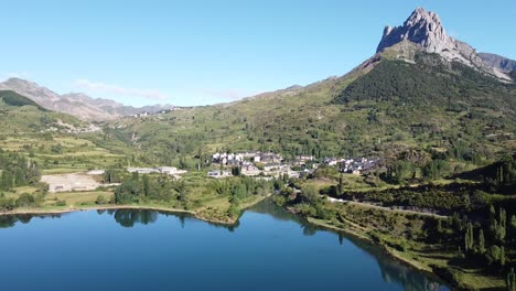 Sallent-de-Gallego-at-Tena-Valley,-Huesca,-Aragon,-Spanish-Pyrenees,-Spain---Aerial-Drone-View-of-the-Mountain-Village-and-Dam-Lake-Embalse-de-Bubal