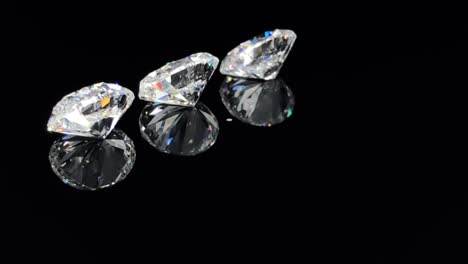 Close-Up-Of-Three-Oval-Brilliant-Cut-Diamonds-Sparkling-And-Rotating-On-Black-Background