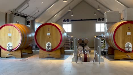 Panning-View-Around-Cellar-With-Wine-Barrels-In-Aging-Process-And-Natural-Light