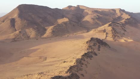 Mountains-in-sandy-desert-near-Zagora,-Morocco