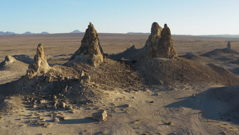 Drone-shot-revealing-5-isolated-pinnacles-in-the-california-desert-at-sunrise