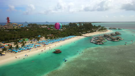 Wide-rotating-drone-shot-of-CoCoCay-island-with-Royal-Caribbean-cruise-ship-in-the-background