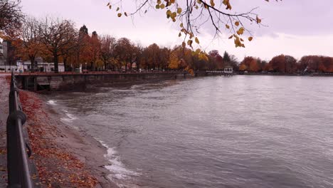 Bregenz-lake-promenade-in-autumn---Lake-Constance-with-autumn-trees---rainy-day