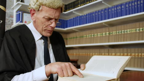 Close-up-of-a-judge-or-barrister-reading-a-law-book-in-the-Judge's-chambers-library