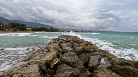 4k-Shot-of-rocks-by-the-harbor-port-and-the-beach-at-Marbella,-Spain