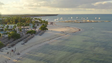 Beautiful-white-sand-beaches-and-warm-tropical-breezes,-calm-water,-Punta-Cana,-aerial-Golden-hour