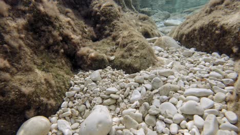 Stones-And-Pebbles-On-A-Clear-Ocean-Water-In-Paralia-Emplisi,-Greece-Europe--Underwater-Shot