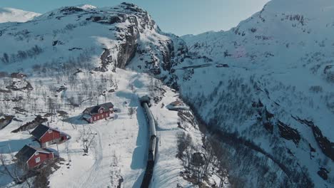 Magical-winter-train-express-riding-form-majestic-mountain-landscape-to-tunnel-in-Norway,-Vatnahalsen