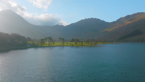 BUTTERMERE-Lake-District-Unesco-National-Park,-Aerial-Sunrise-push-forward-to-head-of-lake-with-trees-and-mountains-Mavic-3-Cine-Prores-422---Clip-1