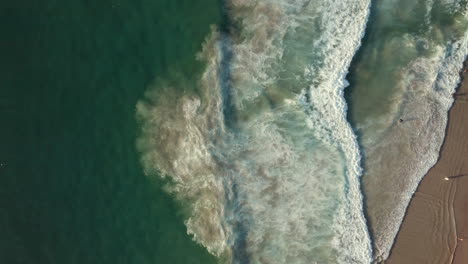 Bird's-Eye-View-Of-Foamy-Waves-In-Llandudno-Beach,-Cape-Town,-South-Africa---aerial-drone