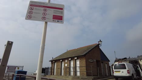 Unusual-sign-with-byelaws-in-Leigh-on-Sea-Essex-UK-toilet-block-in-background