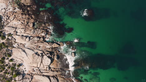 Top-down-View-Of-Rocky-Coast-At-Llandudno-Beach,-Cape-Town,-South-Africa---aerial-drone-shot
