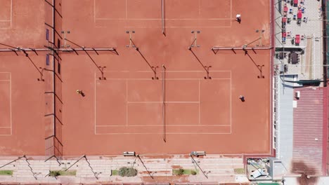 Tennis-match-of-two-players-on-clay-court-seen-from-above