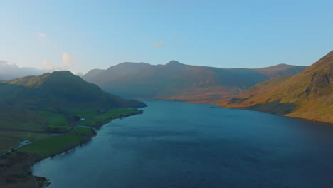 CRUMMOCK-WATER-Lake-District-Unesco-National-Park,-Aerial-Sunrise-push-forward-at-altitude-over-lake-with-sun-dappled-mountains-Mavic-3-Cine-Prores-422---Clip-4