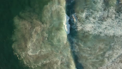 Ocean-Waves-Breaking-With-White-Foam-At-Llandudno-Beach,-Cape-Town,-South-Africa---aerial-top-down