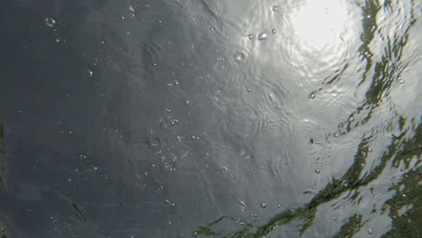 Stones-Drop-On-Clear-Water-Creating-Bubbles