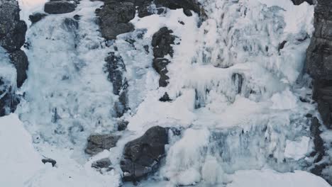 Majestic-view-of-frozen-waterfall-on-massive-mountain-side-in-Norway