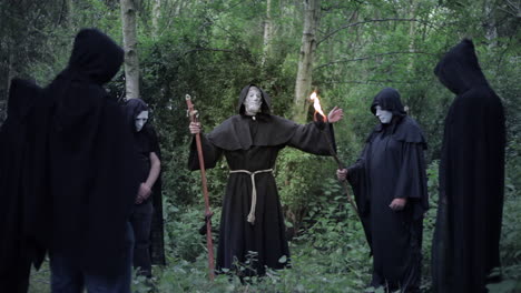 A-circle-of-evil-hooded-druids-in-a-cult-performing-a-sorcery-ritual