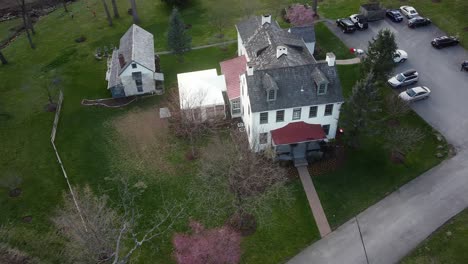 Drone-footage-over-house-and-parking-space-at-suburb-residential-area-in-Chesterbrook,-Pennsylvania,-USA