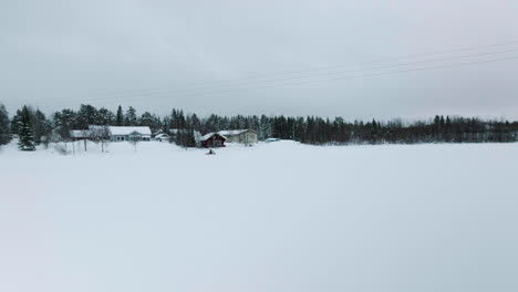 Man-Driving-A-Snowmobile-During-Winter-Season-In-Muonio,-Finland-Near-Lapland--Tracking-Shot
