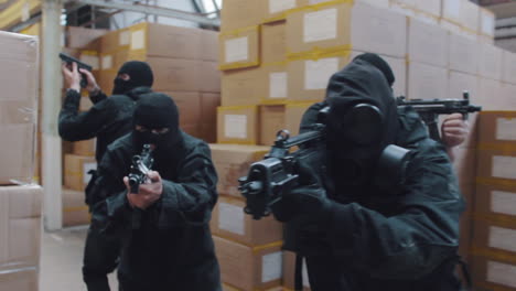 A-special-forces-military-team-raid-a-warehouse-with-guns-drawn-wearing-balaclavas-an-gas-masks