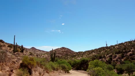 4K-Drone-Passing-By-Car-On-Dirt-Road-In-Arizona-Desert