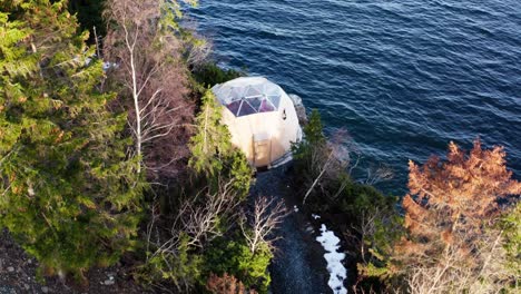 Arctic-Dome-On-The-Cliff-Surrounded-With-Trees-And-Water