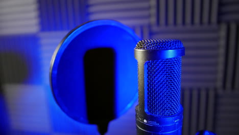 Close-up-of-a-condenser-capacitor-microphone-in-a-voice-over-podcast-vocal-booth-in-a-recording-studio